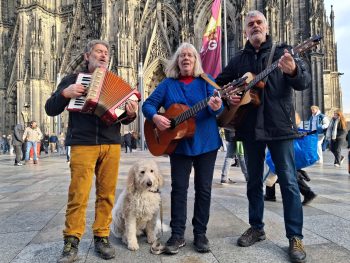 Drei Vokalisten und ein Hund teilen eine  besondere Leidenschaft für „Leeder op Platt“. Bild: 3 mit Fritz