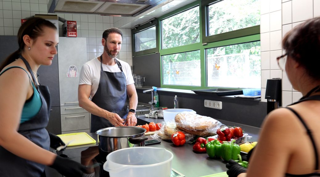 In der Küche half Daniel Ruland beim Zubereiten der Grillsalate und unterhielt sich mit den „Kolleginnen“ über deren Zukunftspläne. Bild: Michael Thalken/Eifeler Presse Agentur/epa